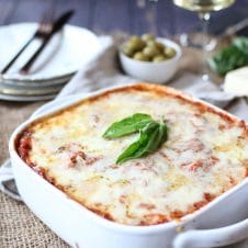 A white baking dish holding a zucchini lasagna with turkey sausage.