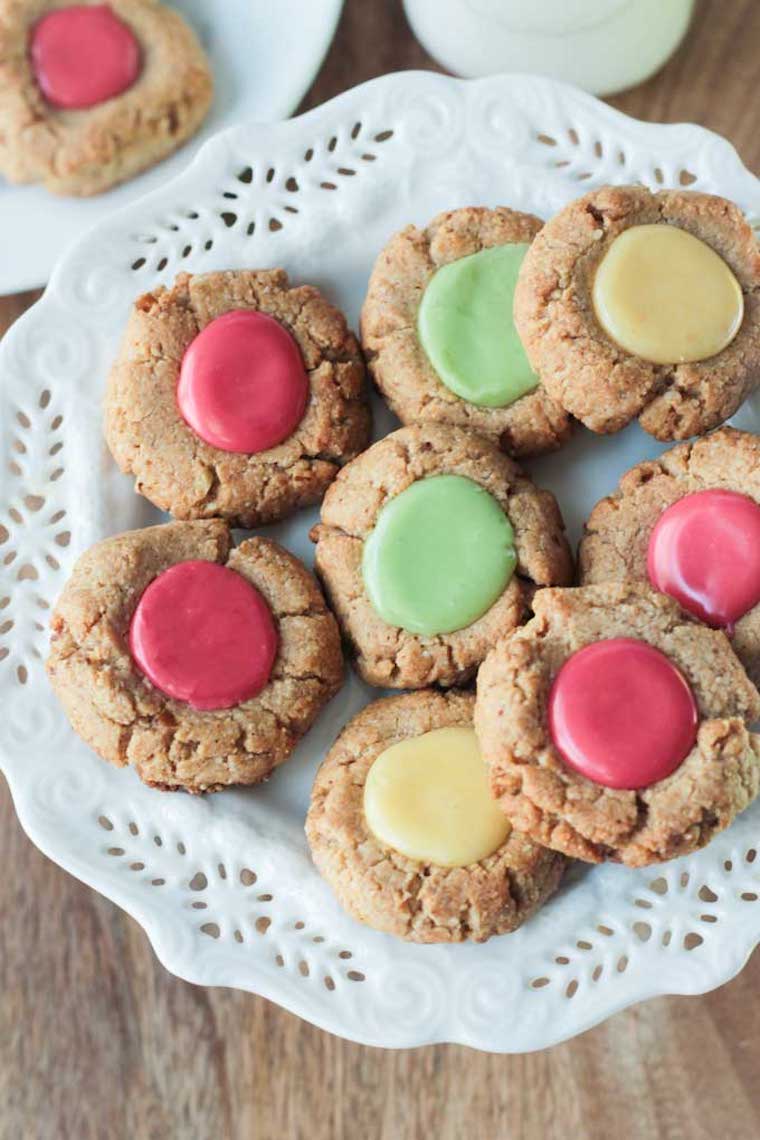 birds eye view of multiple vegan and gluten free thumbprint cookies on a floral plate