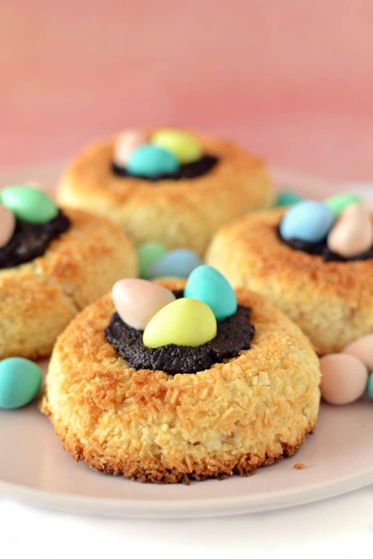 four vegan and gluten free coconut macaroon nests farnished with easter mini eggs