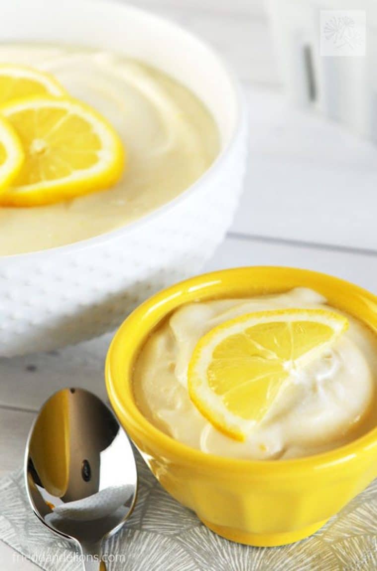 close up of gluten free vegan lemon jello salad garnished with fresh lemon in a yellow ramekin