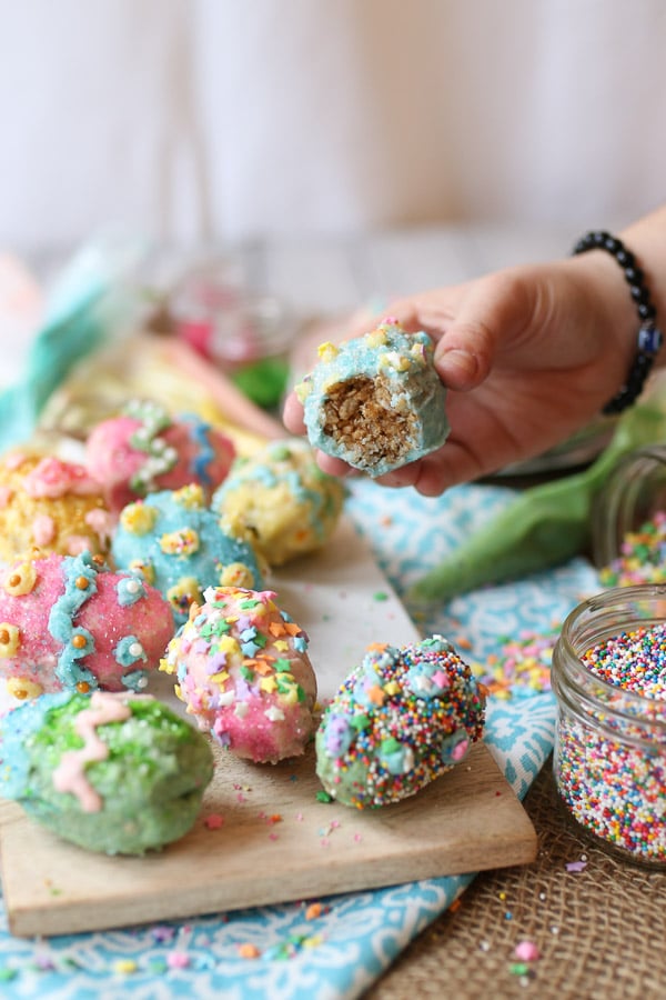 persons hand lifting easter eggs after having taken a bite 