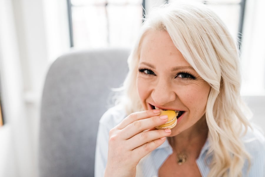 Woman eating a macaroon for pregnancy food safety.