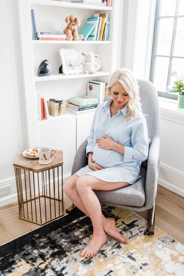 Abbey Sharp, pregnant, sitting in a chair.