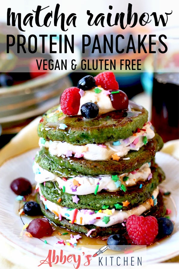 pinterest image of Stack of matcha rainbow protein pancakes on a white plate with text overlay