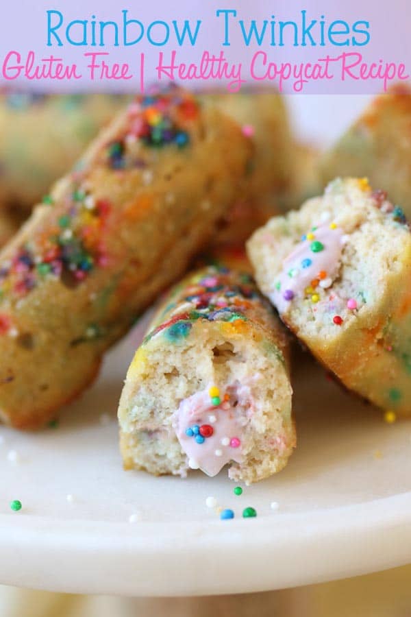 close up image of gluten free rainbow twinkies stacked on top of each other on a white plate