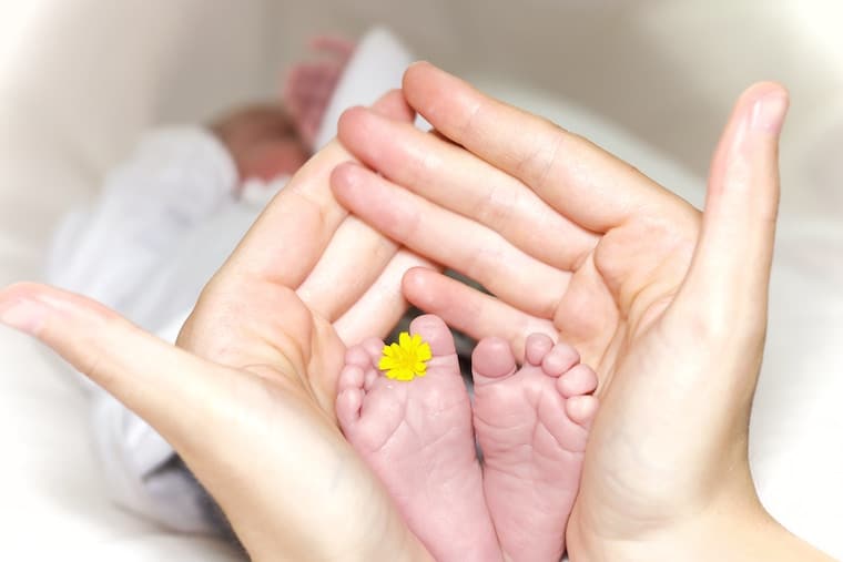 hands holding baby feet