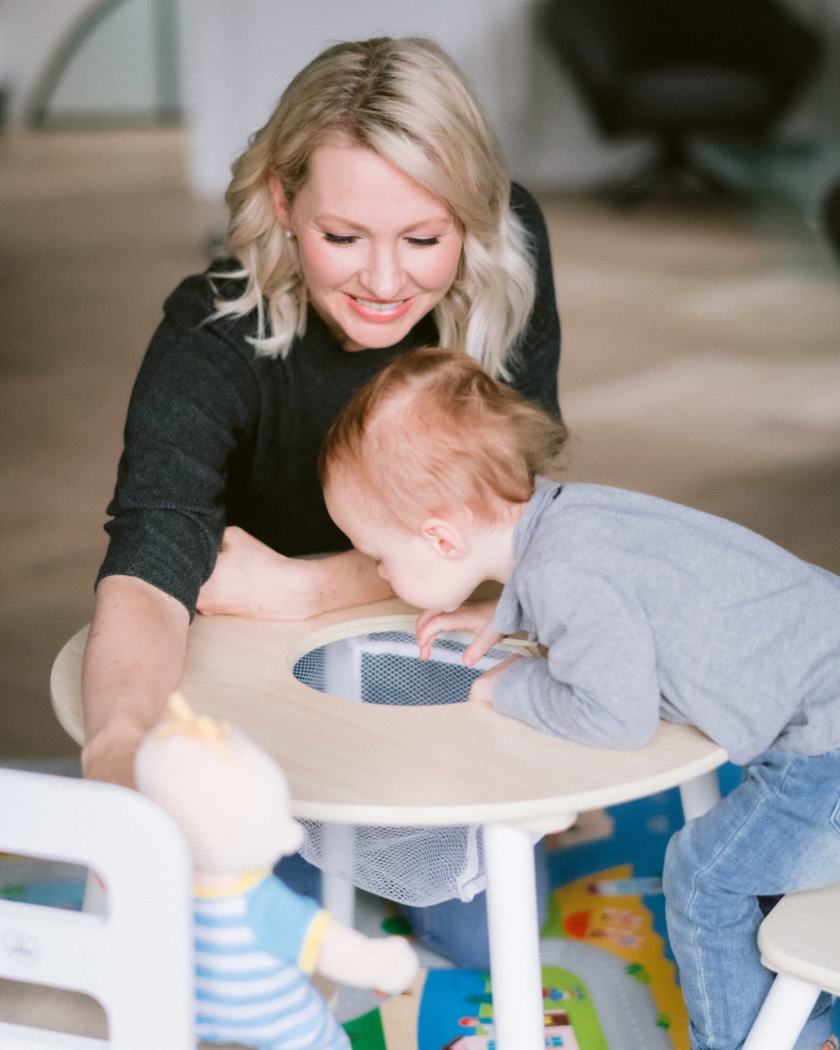 abbey and baby e sitting at a table doing toddler activities together from home