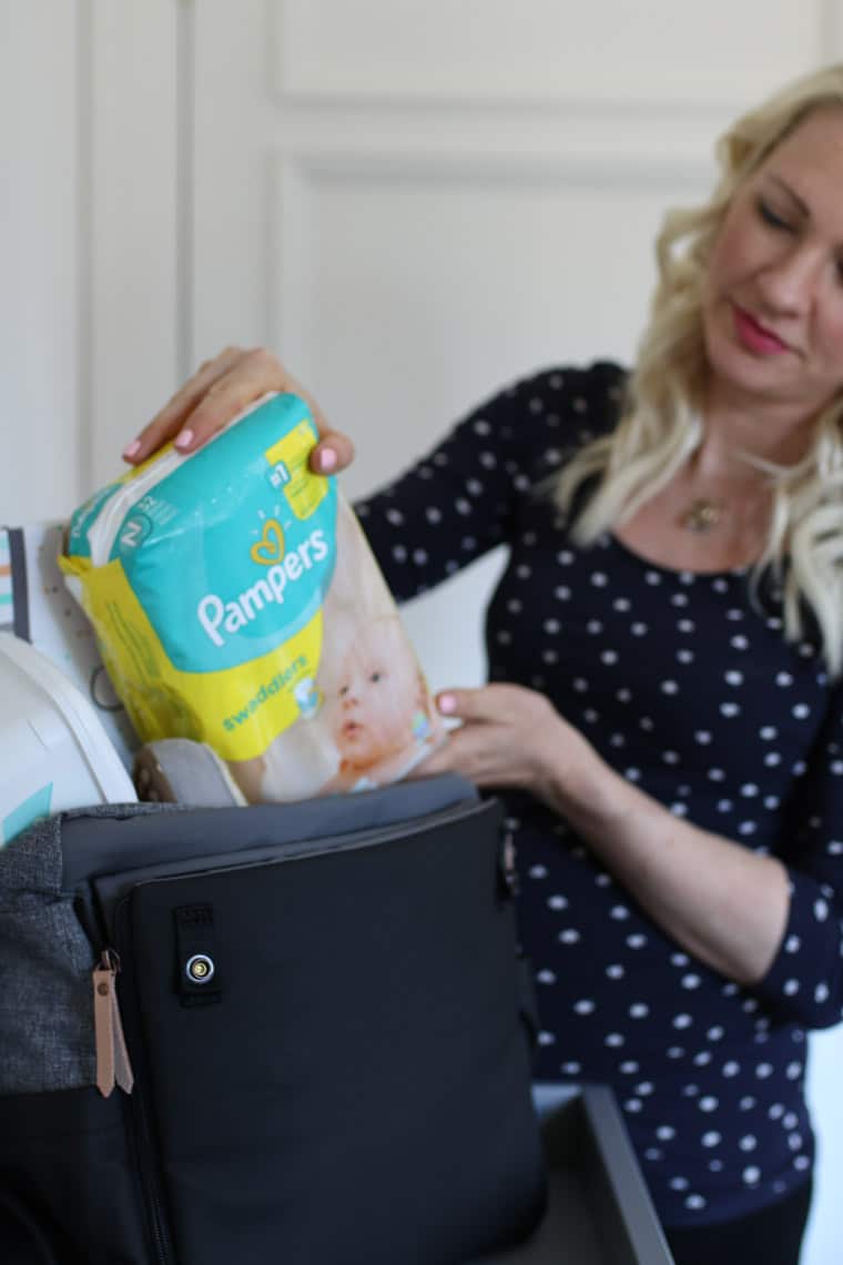 Abbey Sharp packing pampers into a bag.