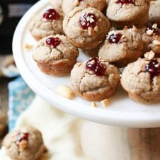 A white plate of blender muffins with a dollop of jam on top.