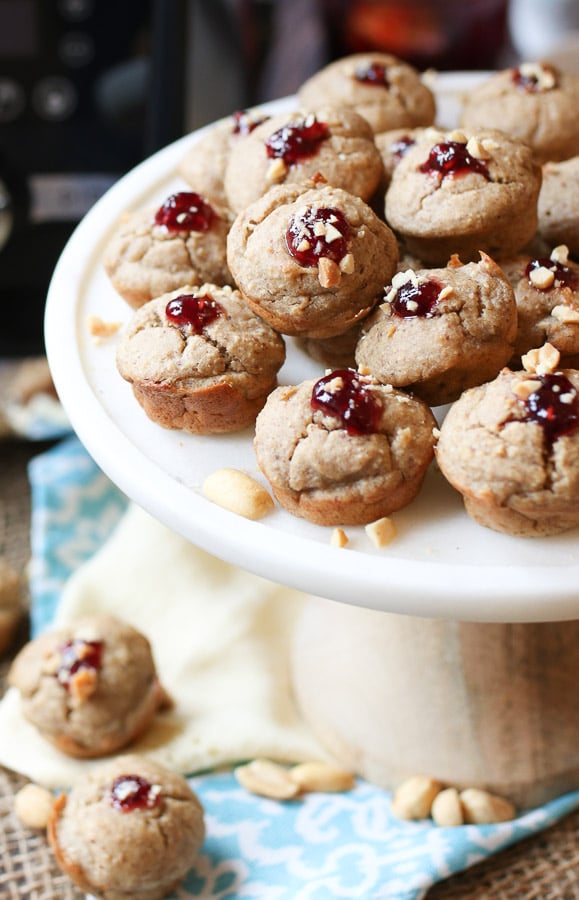 A white plate of blender muffins with a dollop of jam on top.