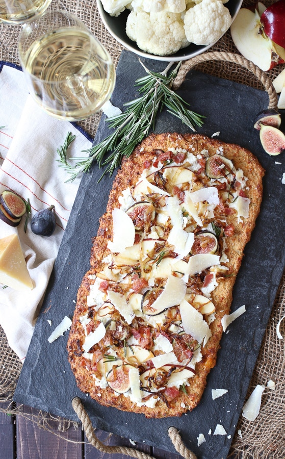 Fig, apple and onion cauliflower pizza flatbread on a serving platter.