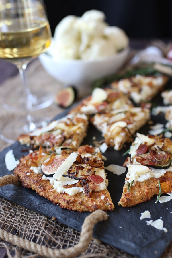 Apple, fig and onion cauliflower pizza flatbread cut into slices.