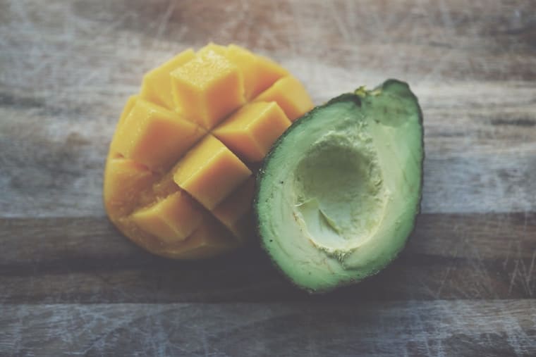 A mango and avocado cut open. 