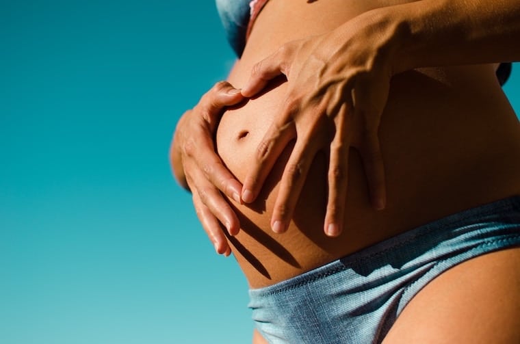 woman holding her pregnant stomach