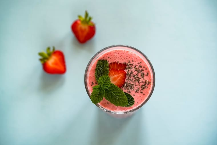 An overhead image of a strawberry smoothie.