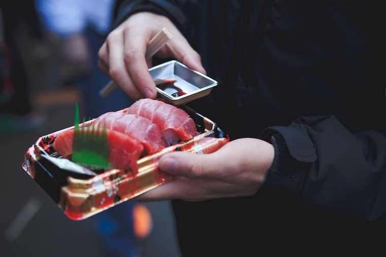 sashimi being served on a rectangular plate