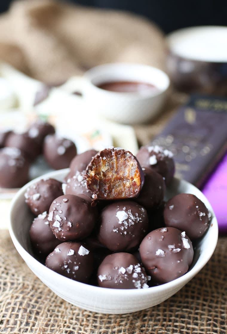 Bowl containing salted tahini date caramel truffles. 