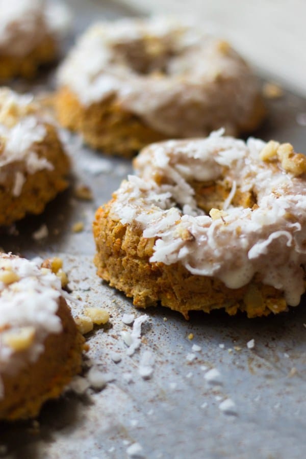 A close up of a carrot cake donut with a coconut glaze.