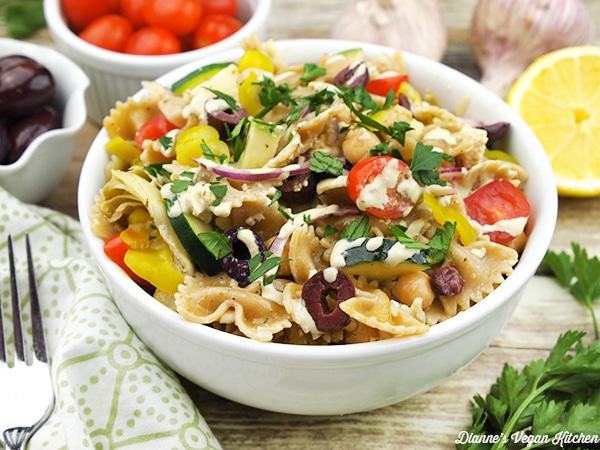 Greek pasta salad in a white bowl. 