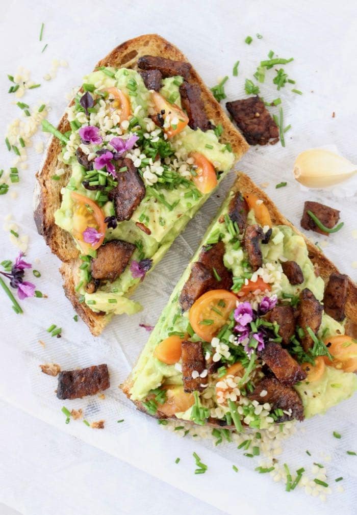 Vegan avocado bruschetta on white linen. 