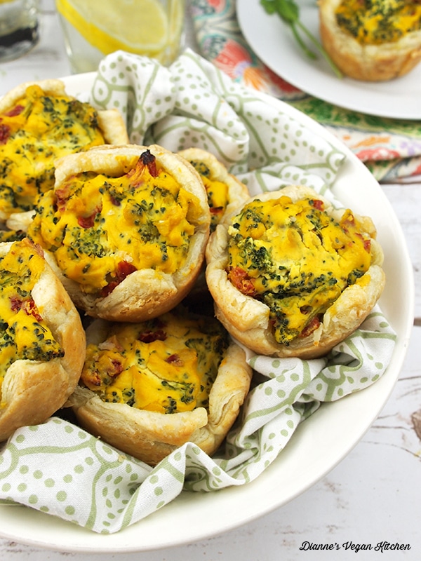 Broccoli quiche cups in a white serving dish. 