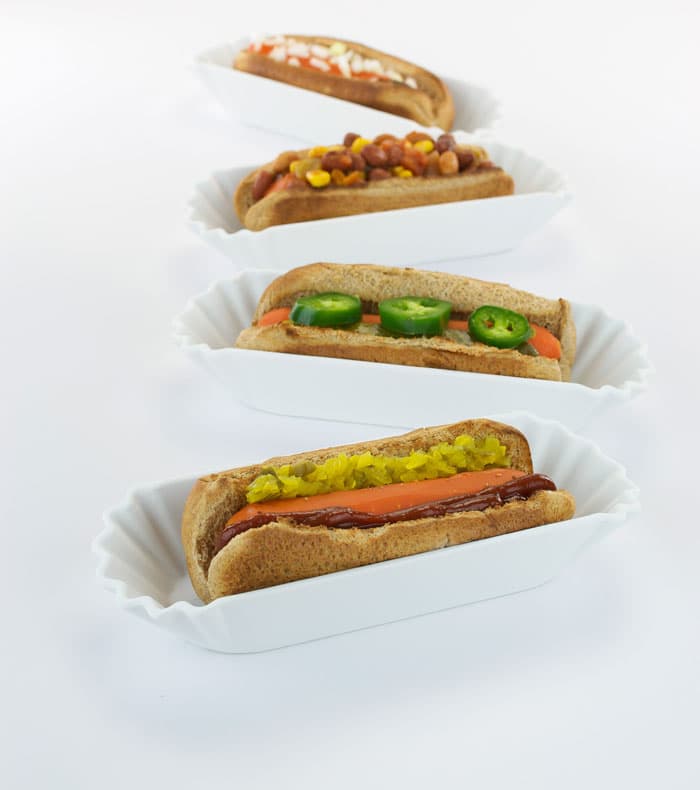 Carrot dogs served in white dishes. 
