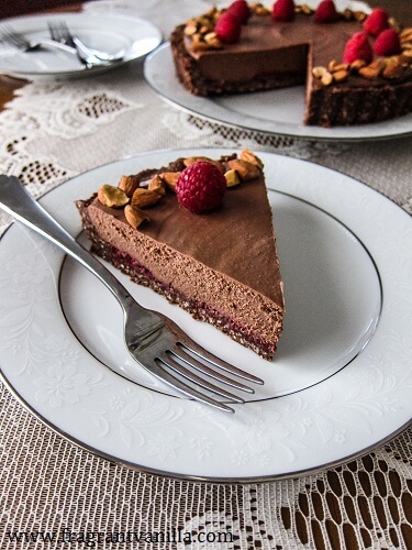 Chocolate mousse cake slice on a white plate. 