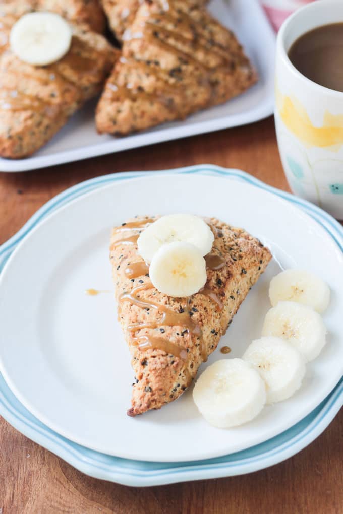 Black sesame scones topped with tahini glaze and banana slices. 