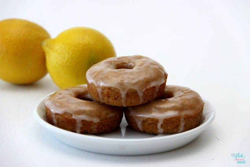 A stack of mini lemon donuts with glaze on top.