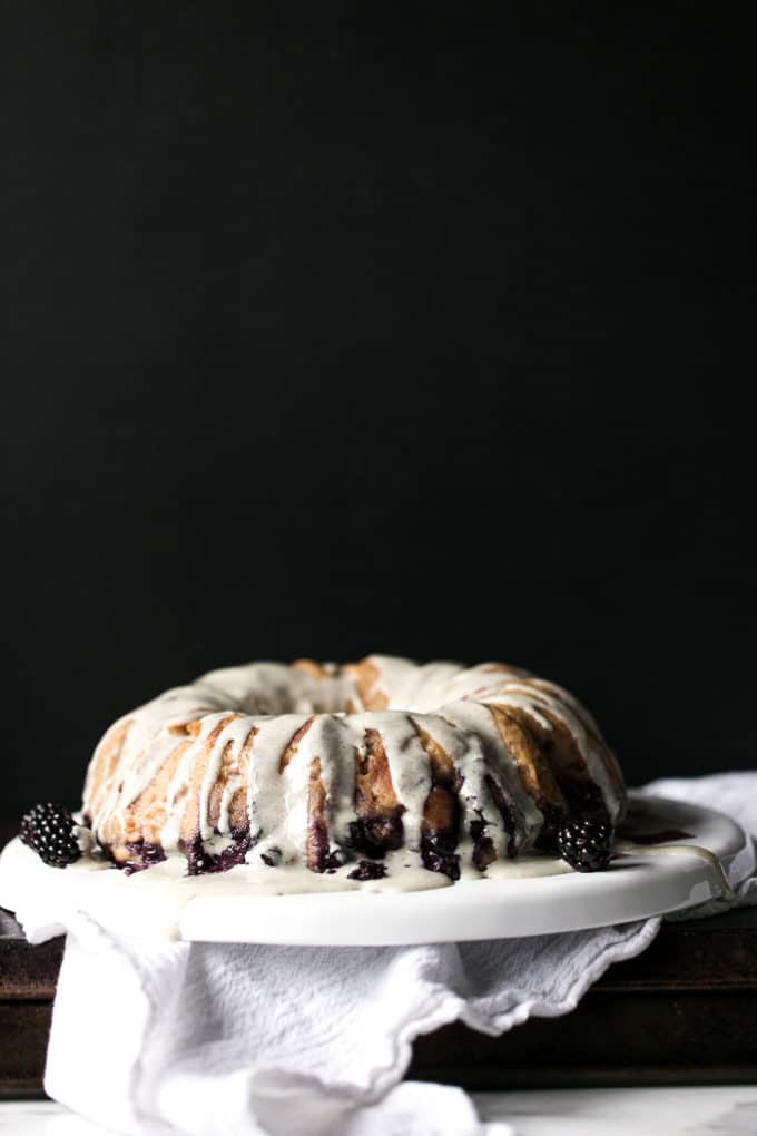 Blueberry bread pudding breakfast cake on a white serving dish. 