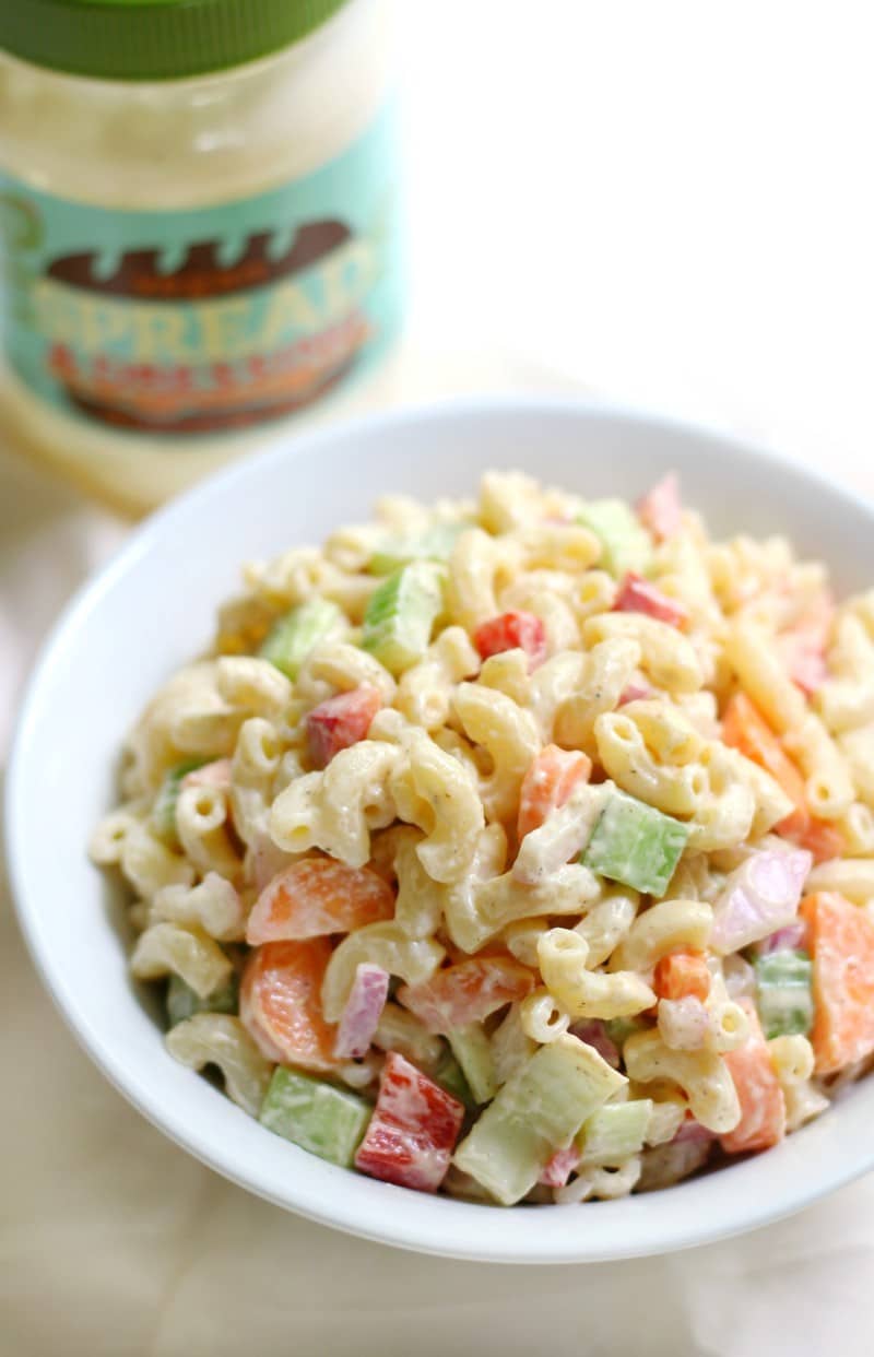 Macaroni salad in a white bowl. 