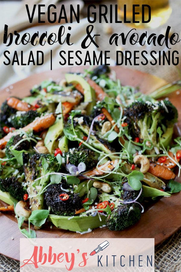 pinterest image of Grilled broccoli and carrot salad on a wooden plate with text overlay