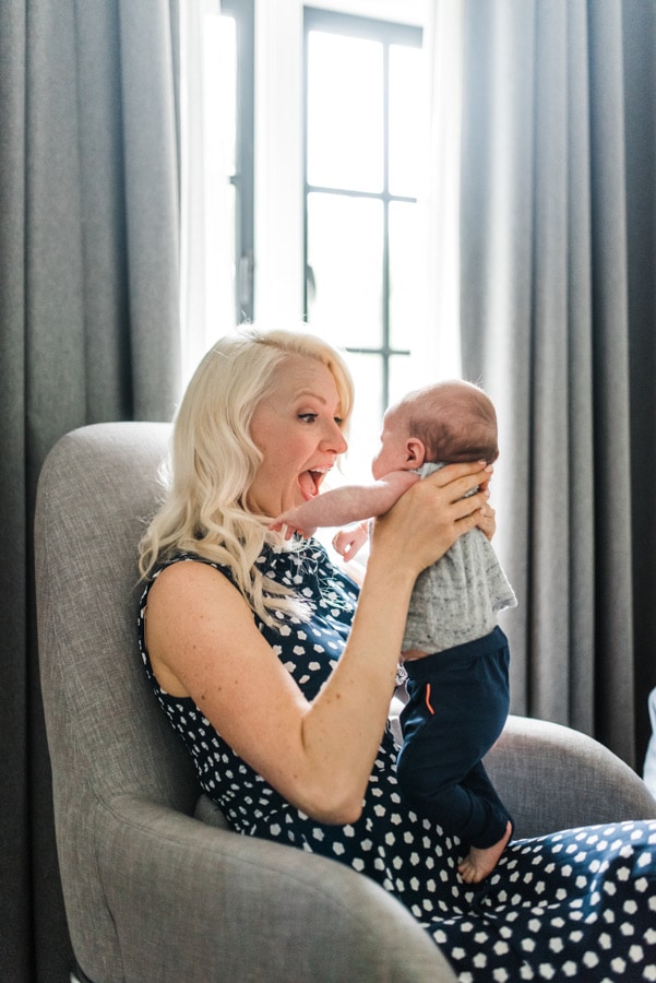 Abbey Sharp playing with a baby discussing mom guilt.