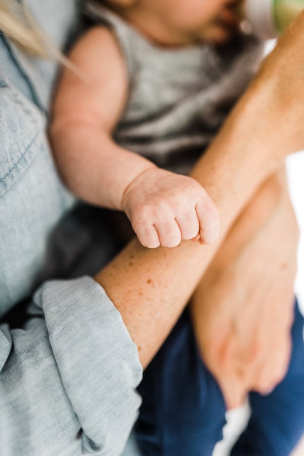 A baby's hand on an arm.