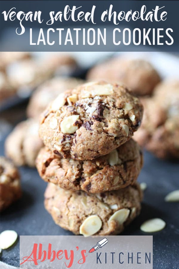 Three chocolate salted almond lactation cookies stacked on a serving plate.