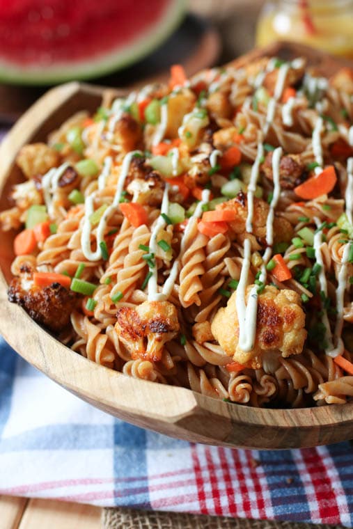 Buffalo cauliflower pasta salad in a wooden bowl. 