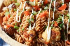 Buffalo cauliflower pasta salad in a wooden bowl.