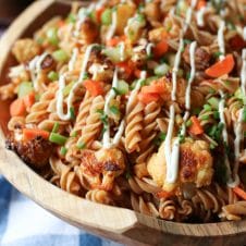 Buffalo cauliflower pasta salad in a wooden bowl.