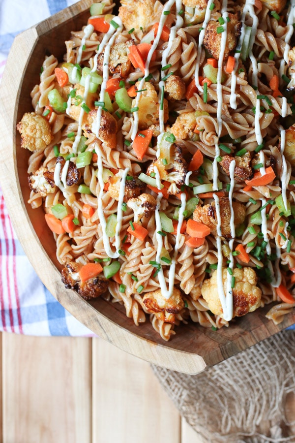 Buffalo cauliflower gluten free pasta salad in a wooden bowl.