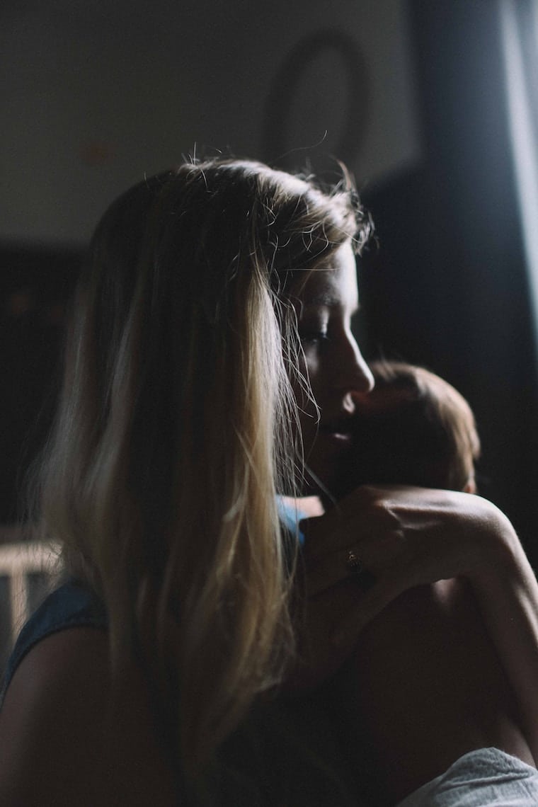 A woman holding a baby.