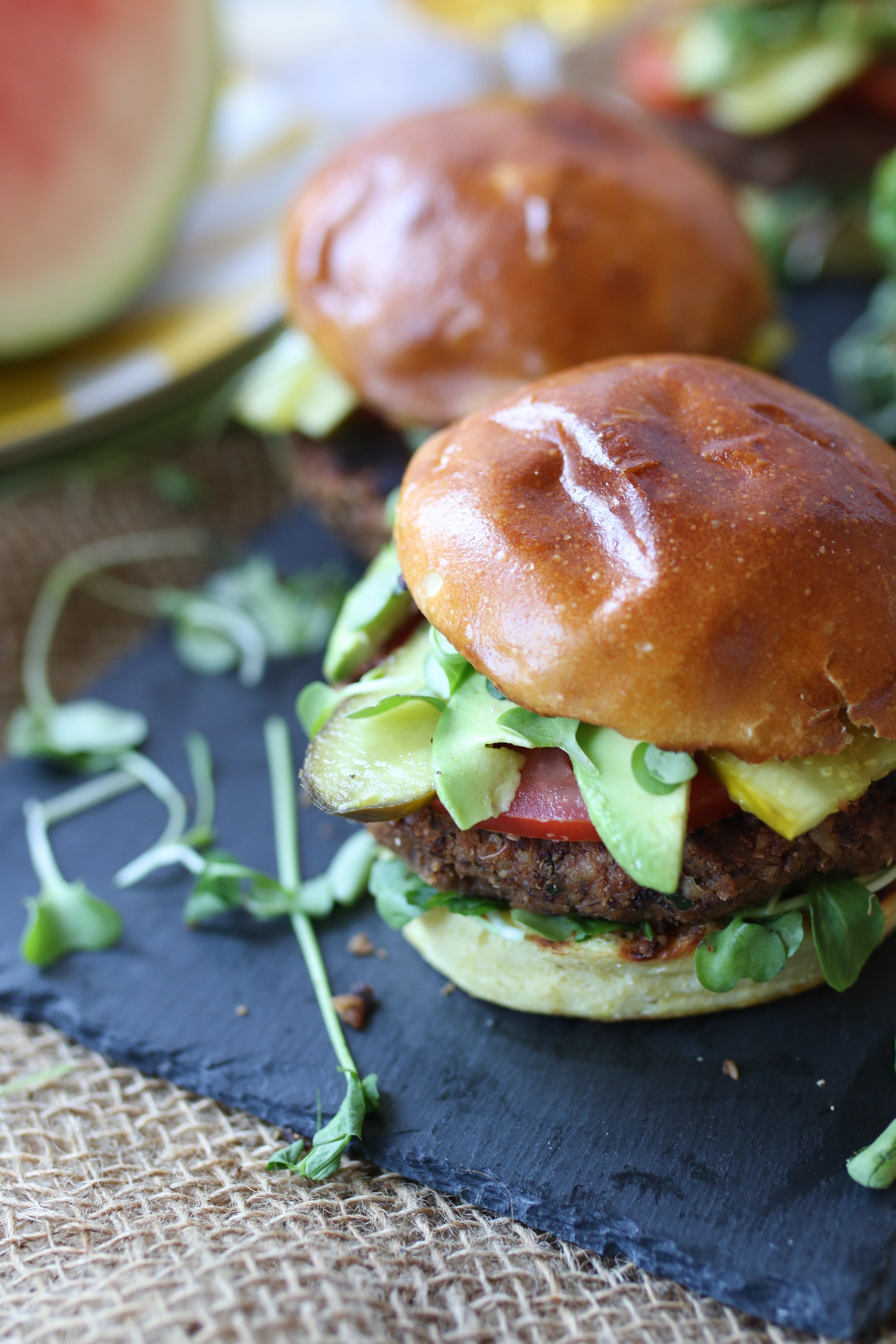 An angle photo of a vegan black bean burger on a serving platter.