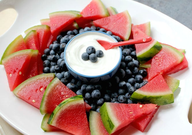 red white and blue fruit platter with yogurt dip in the centre 