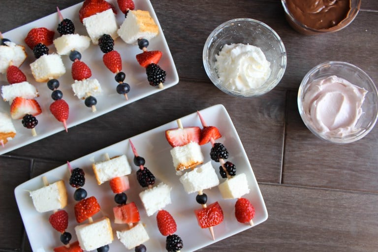 birds eye view of red white and blue angel food cake skewers on white plates