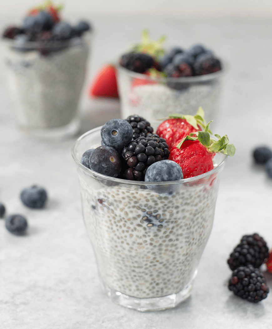 gluten free and vegan soy berry chia pudding in clear glasses topped with berries