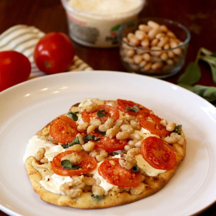 Tomato white bean naan pizza