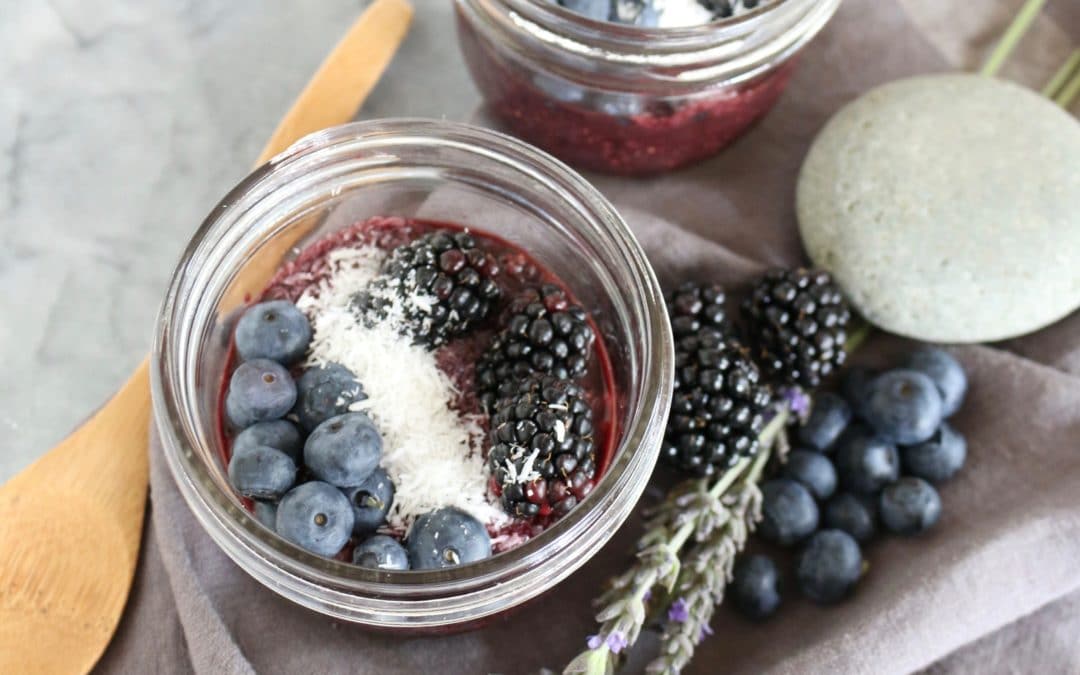 close up of gluten free vegan super berry acai bowl topped with fresh fruit