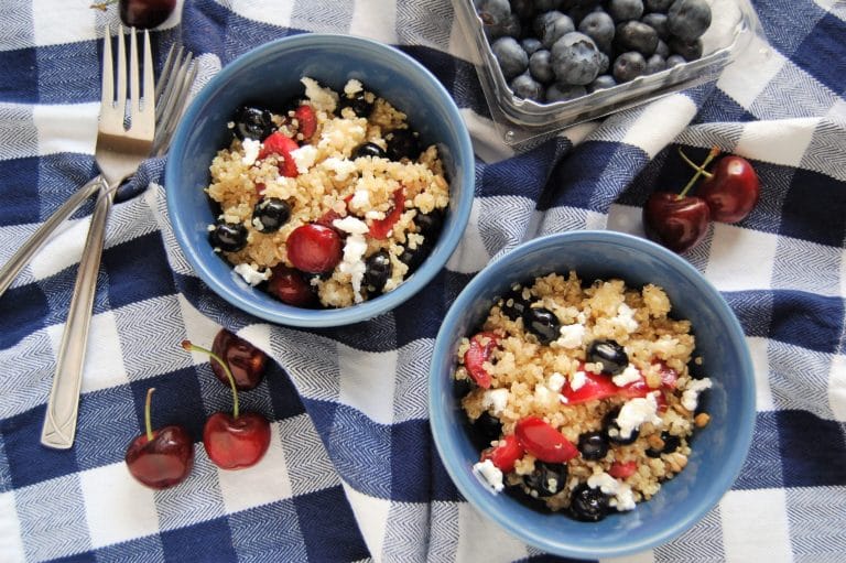 birds eye view of gluten free fruity quinoa salad in blue bowls