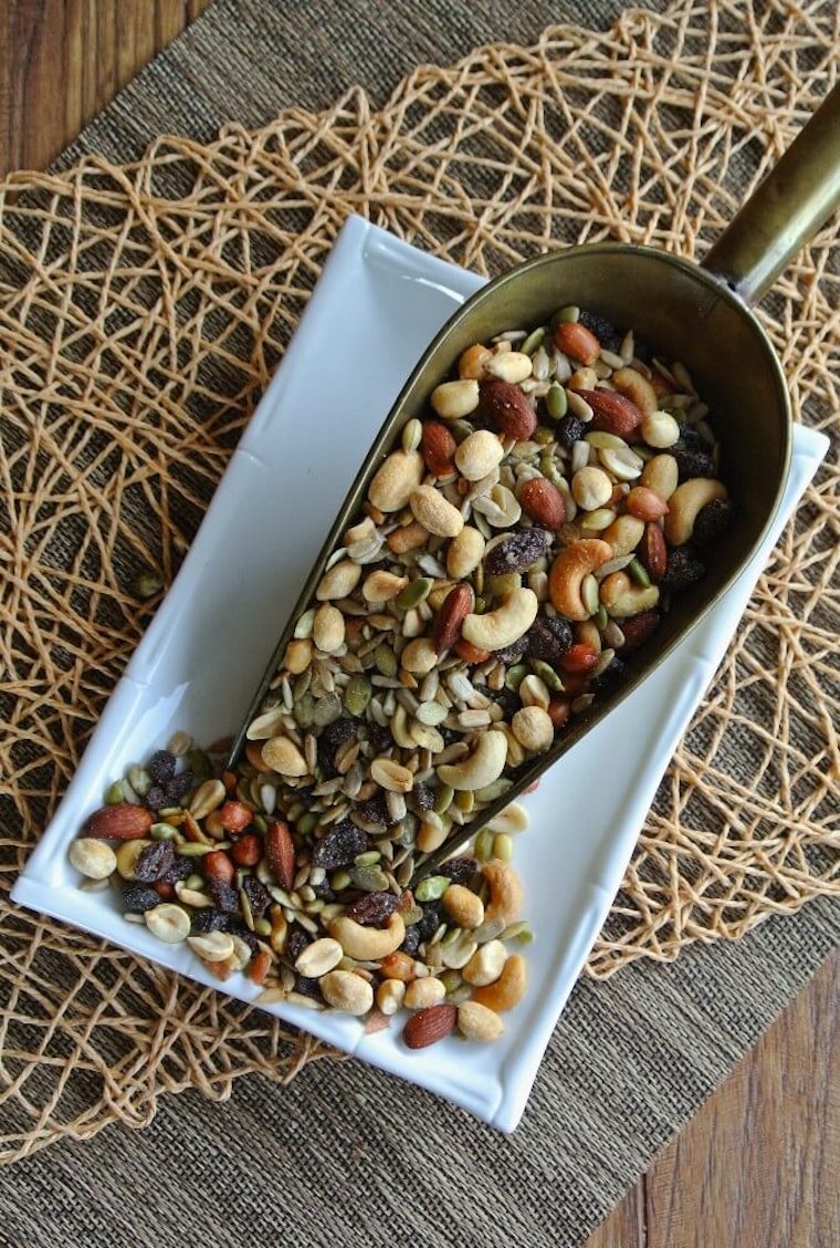 birds eye view of sweet and salty trail mix on a white plate