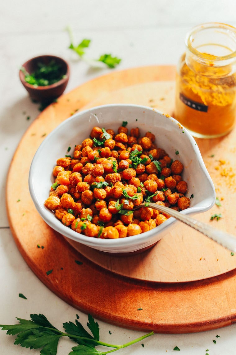 crispy baked chickpeas in a white bowl with a spoon
