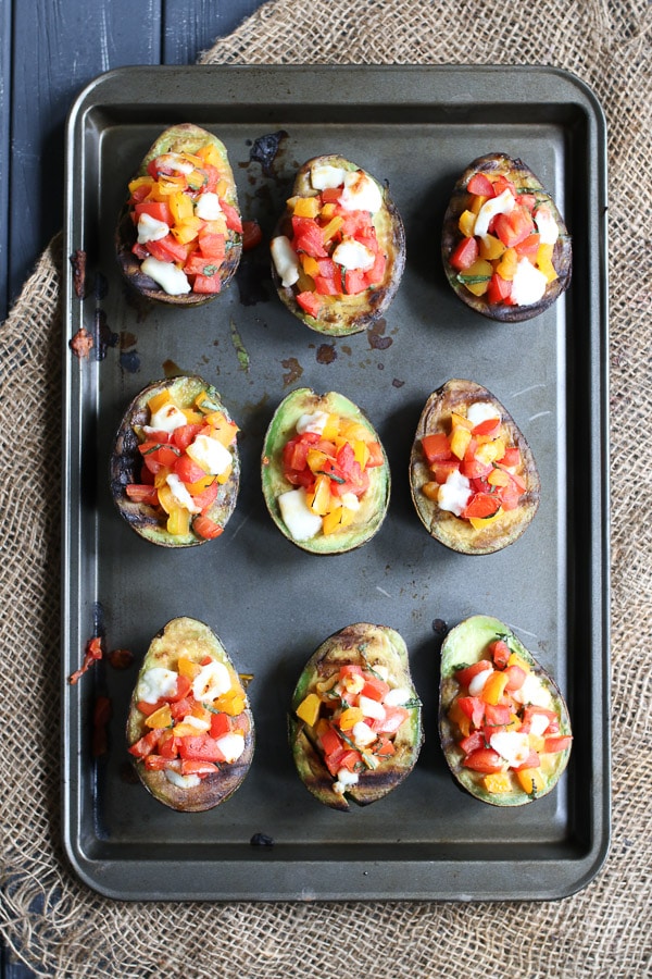 Grilled avocado bruschetta on a baking sheet. 